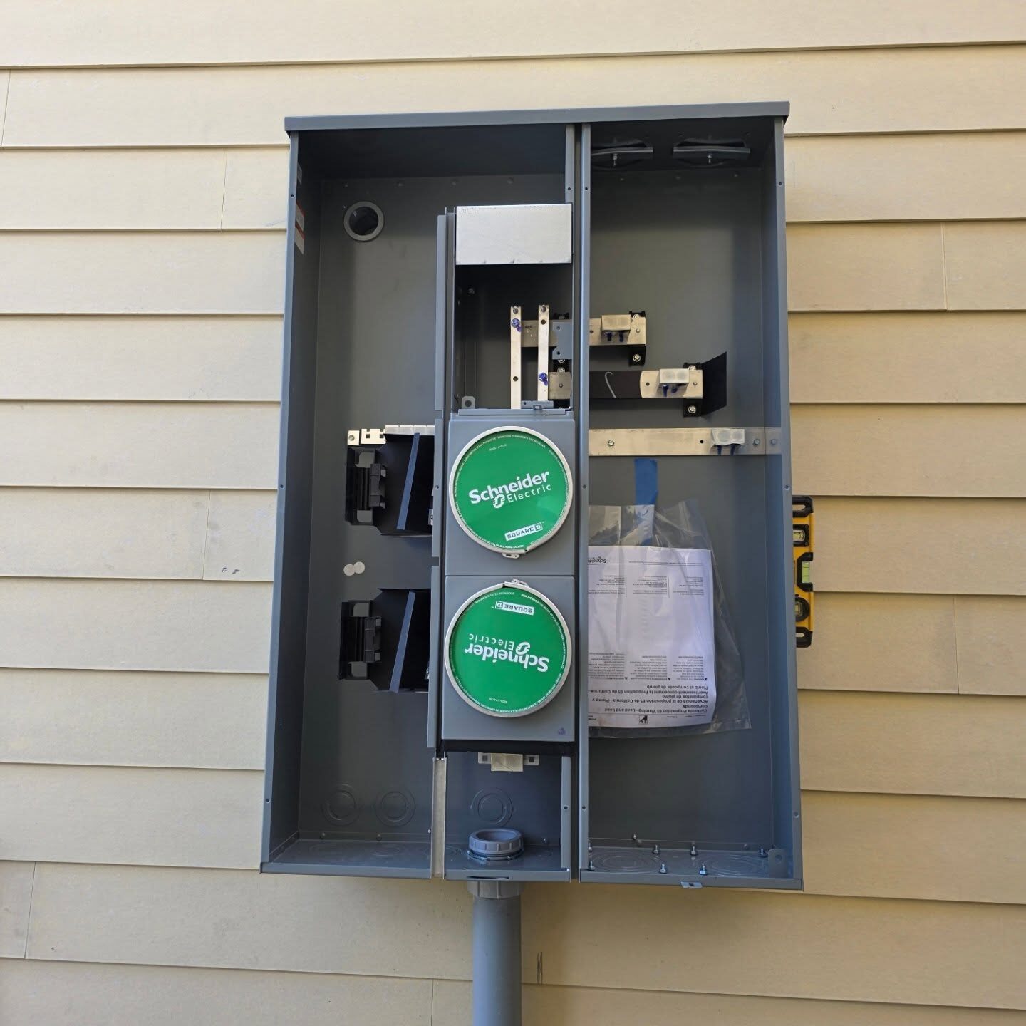 Open 400-amp meter and panel enclosure with meter sockets during a service upgrade