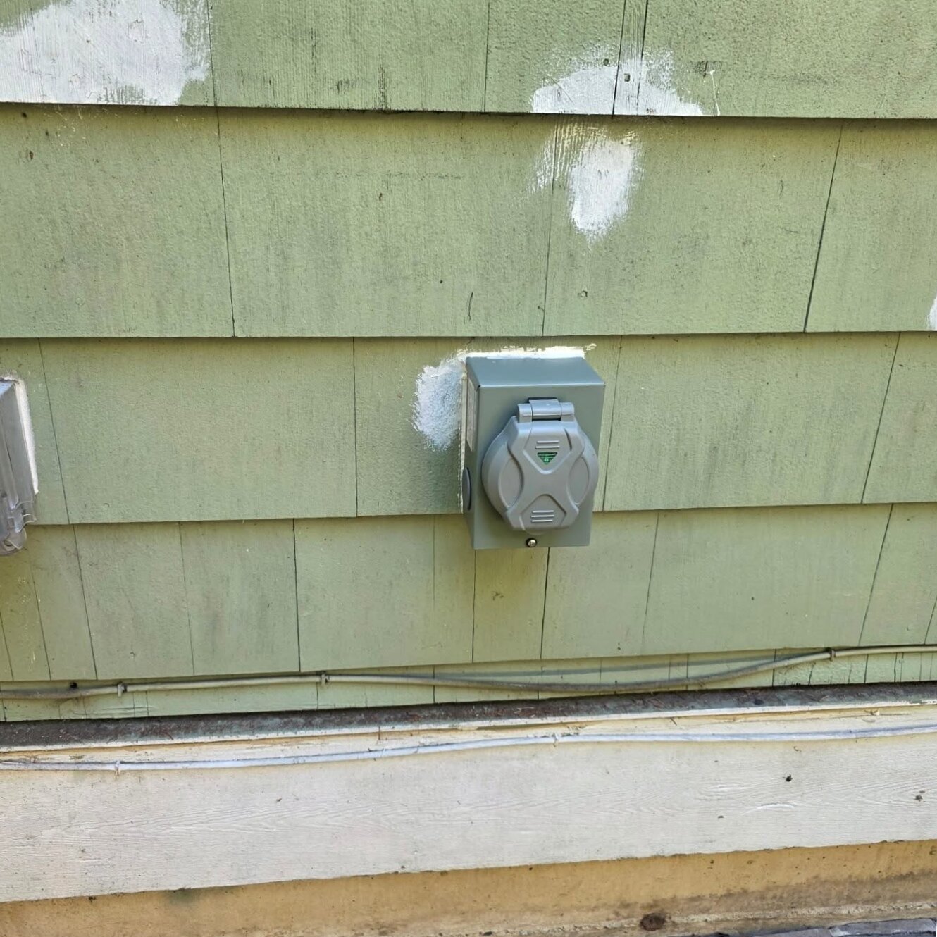 Finished generator power inlet box mounted cleanly on exterior siding